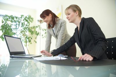 two woman working at a computer
