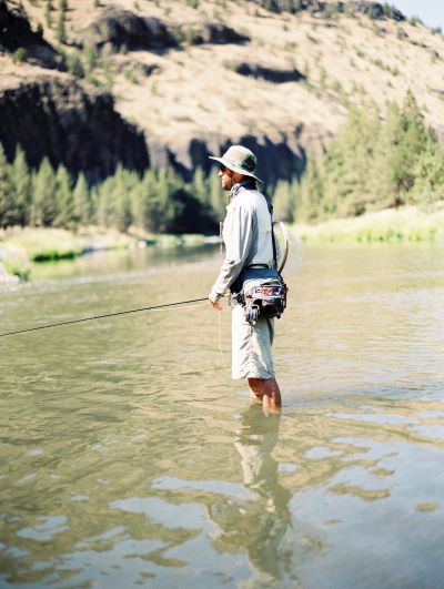 a person in a river fly fishing