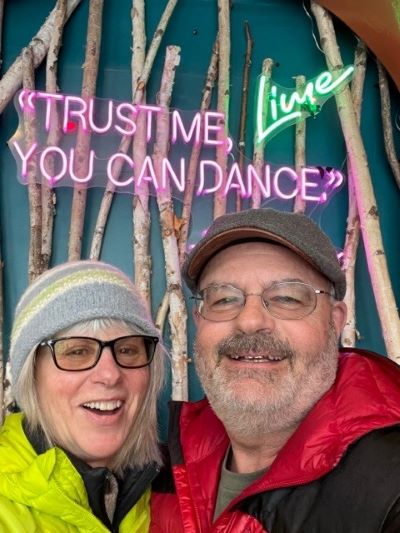 an elderly couple smiling at a dance club